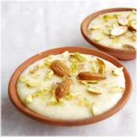 Romige rijstpudding gemaakt van fijn gemalen rijst, langzaam gekookt in volle melk en gezoet met suiker. Afgemaakt met kardemom en een vleugje saffraan voor een zachte, aromatische smaak. Gegarneerd met pistachenoten